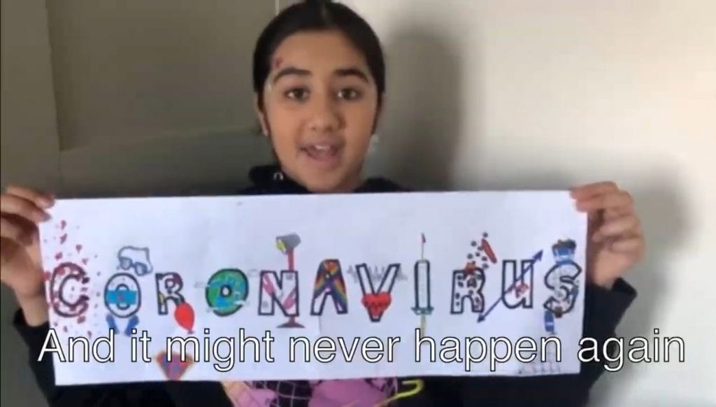 Kaya holding a sign that says "Coronavirus"