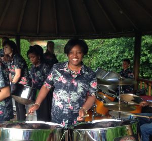 A woman playing a steel drum