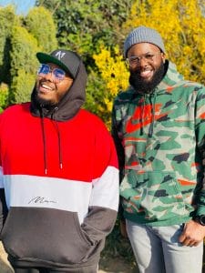 Two men standing next to each other in an outdoor setting