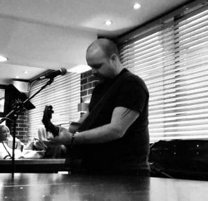 An upper body photo of a man. Black and white.