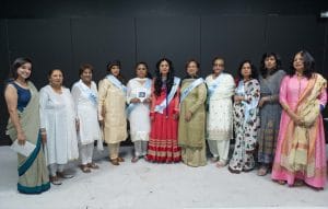 A group of South Asian women dressed in brightly coloured saris