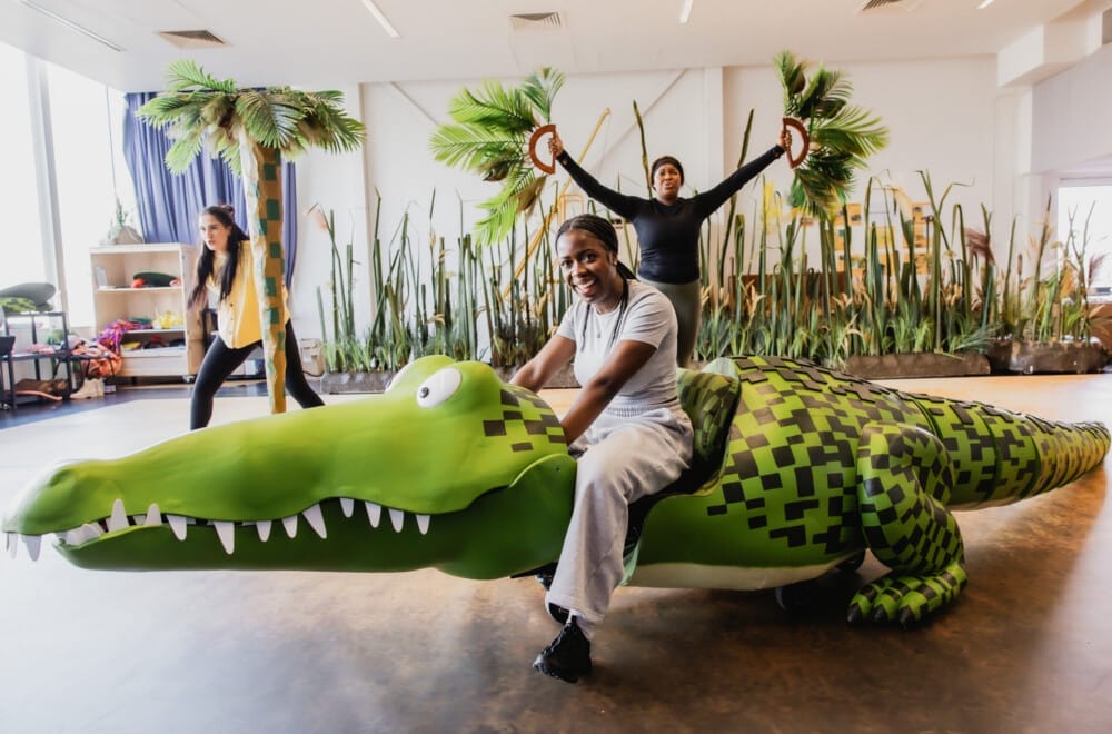 The UK Tour cast rehearsing The Enormous Crocodile.