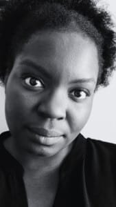 A black and white image of a young Black woman wearing a black shirt.