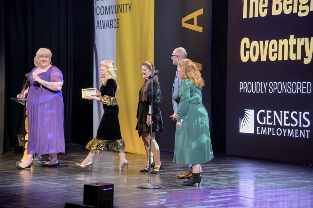 Interim CEO Emma Flatley, Interim COO Jo Philips and Head of People & Culture Scarlet Morgan accept the People First Award on stage at the Chamber Awards 2026.